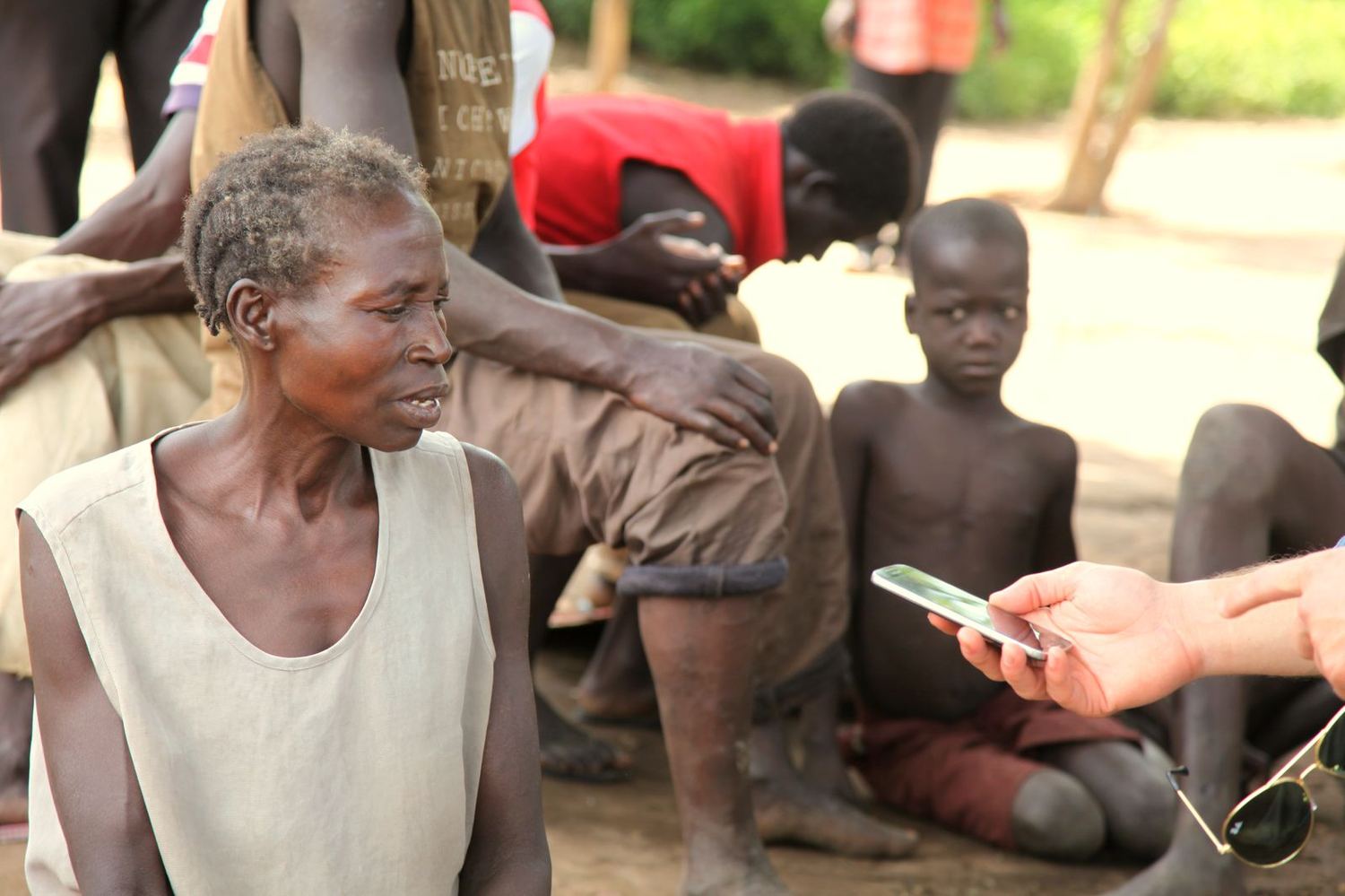 A field researcher listening attentively to a community elder
